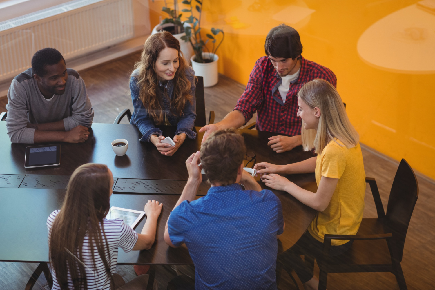 Team discussing ideas around a conference table Team discussing ideas around a conference table